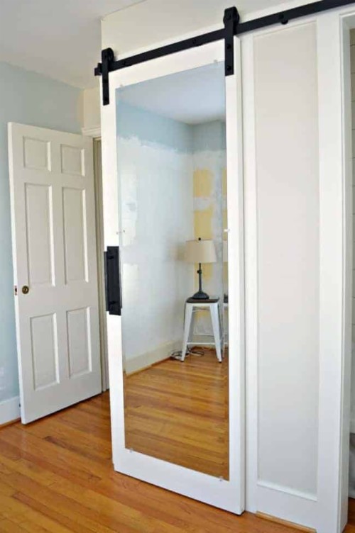 Hanging White Mirrored Barn Door On Bedroom Closet